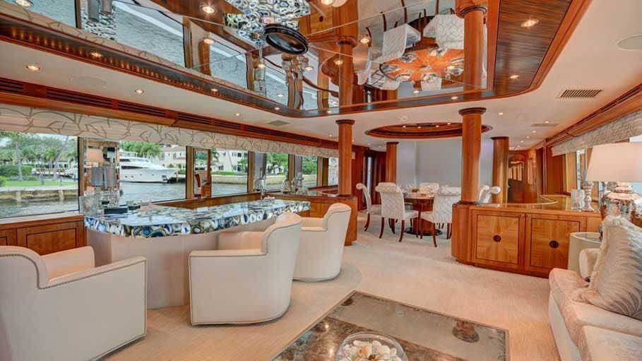 A living room filled with furniture and a large mirrored ceiling.