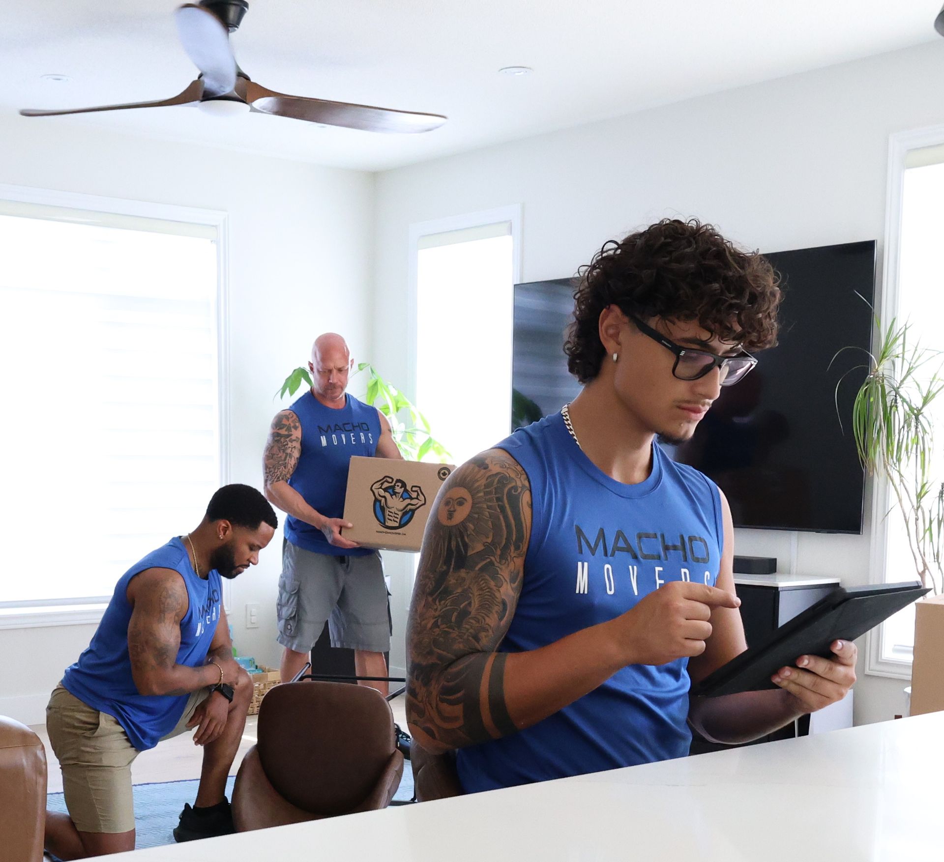 a delivery man is talking to a woman while holding a clipboard .