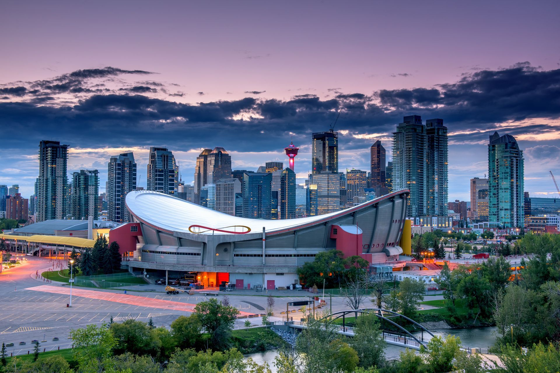 An aerial view of a city skyline with a stadium in the foreground.