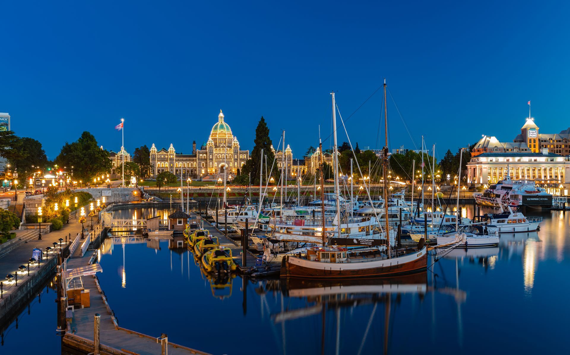 A harbor filled with boats and buildings at night.