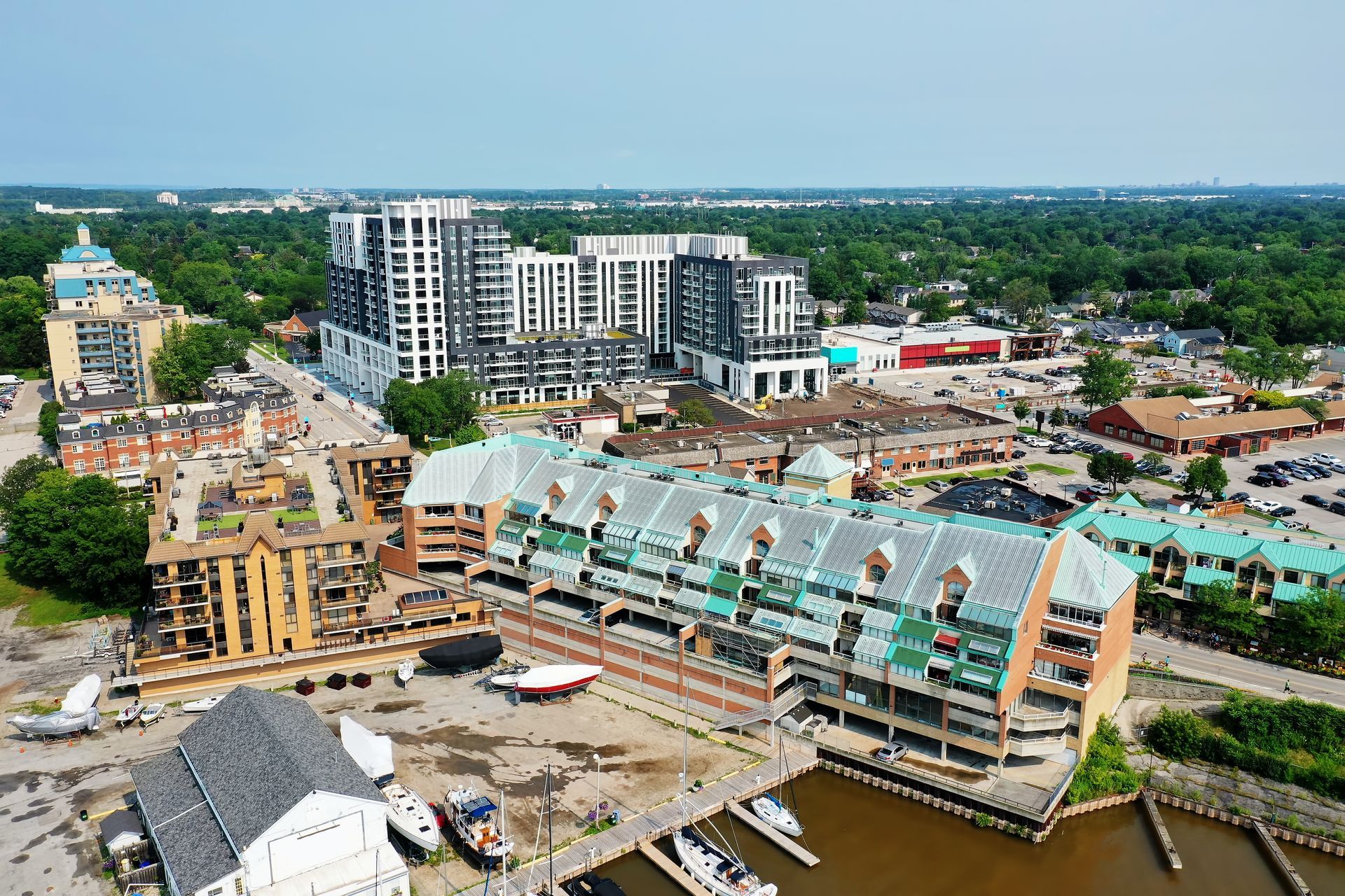 An aerial view of a city with lots of buildings and boats in the water.