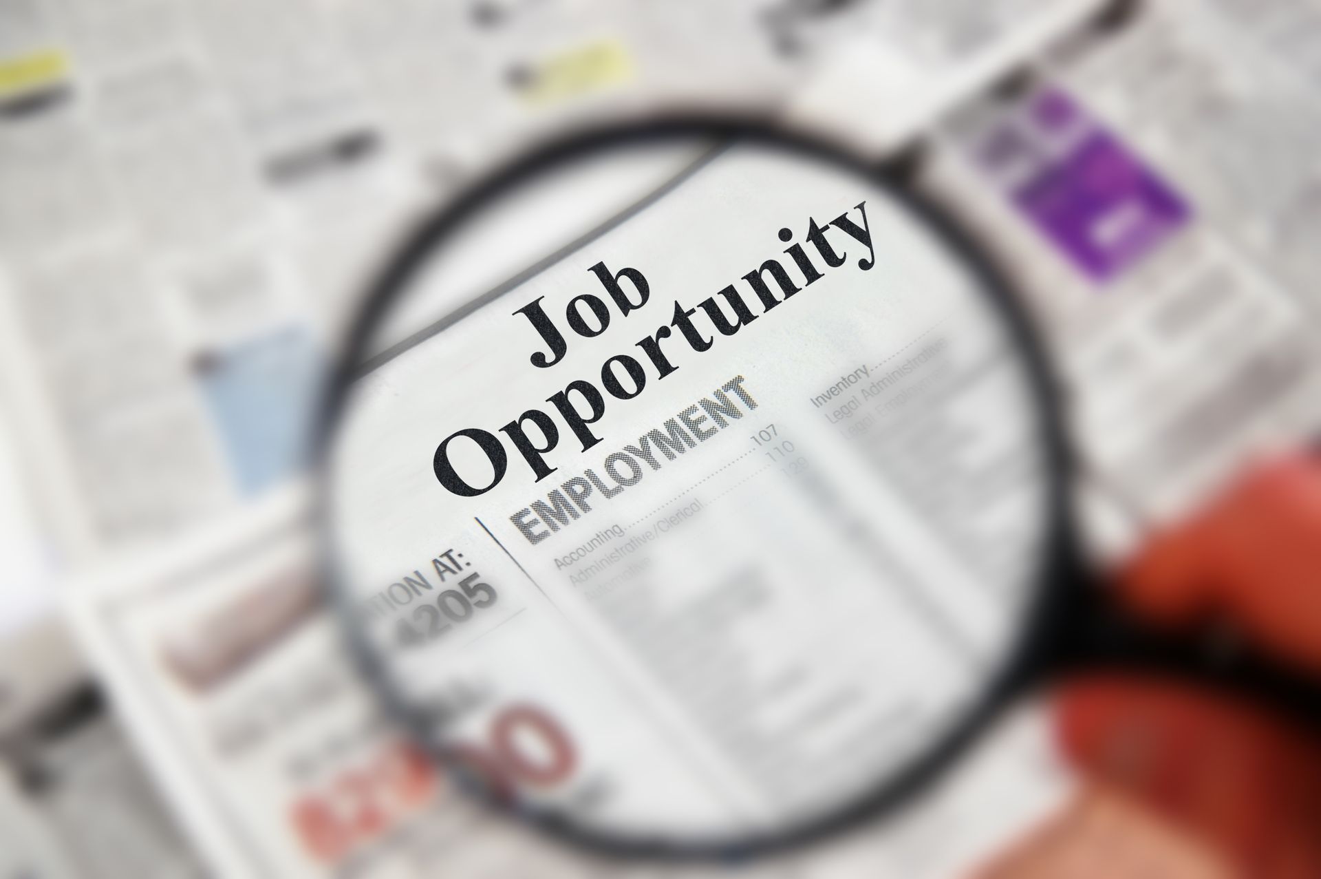 Magnifying glass over newspaper headline