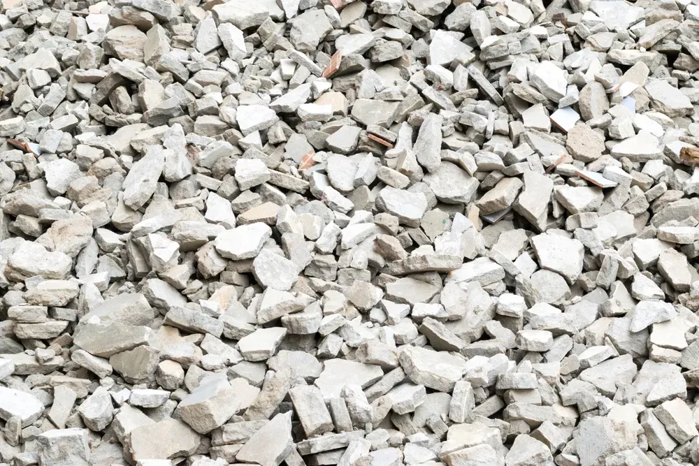 Pile of light gray crushed stone or gravel filling the frame — Coastal Sand Soil & Mulch in Urangan, QLD