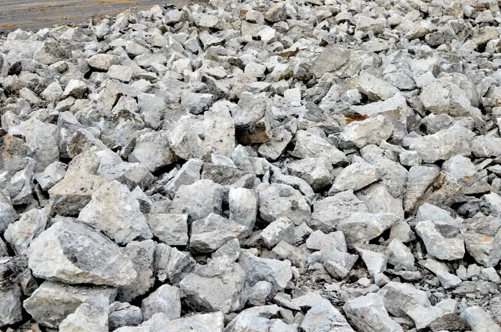 Pile of light gray broken rocks and rubble filling the frame — Coastal Sand Soil & Mulch in River Heads, QLD