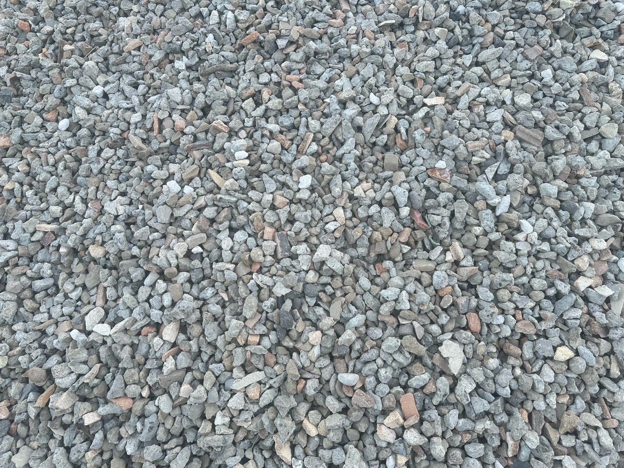Close-up Of Small Gray and Tan Gravel Stones Covering the Ground — Coastal Sand Soil & Mulch Craignish, QLD