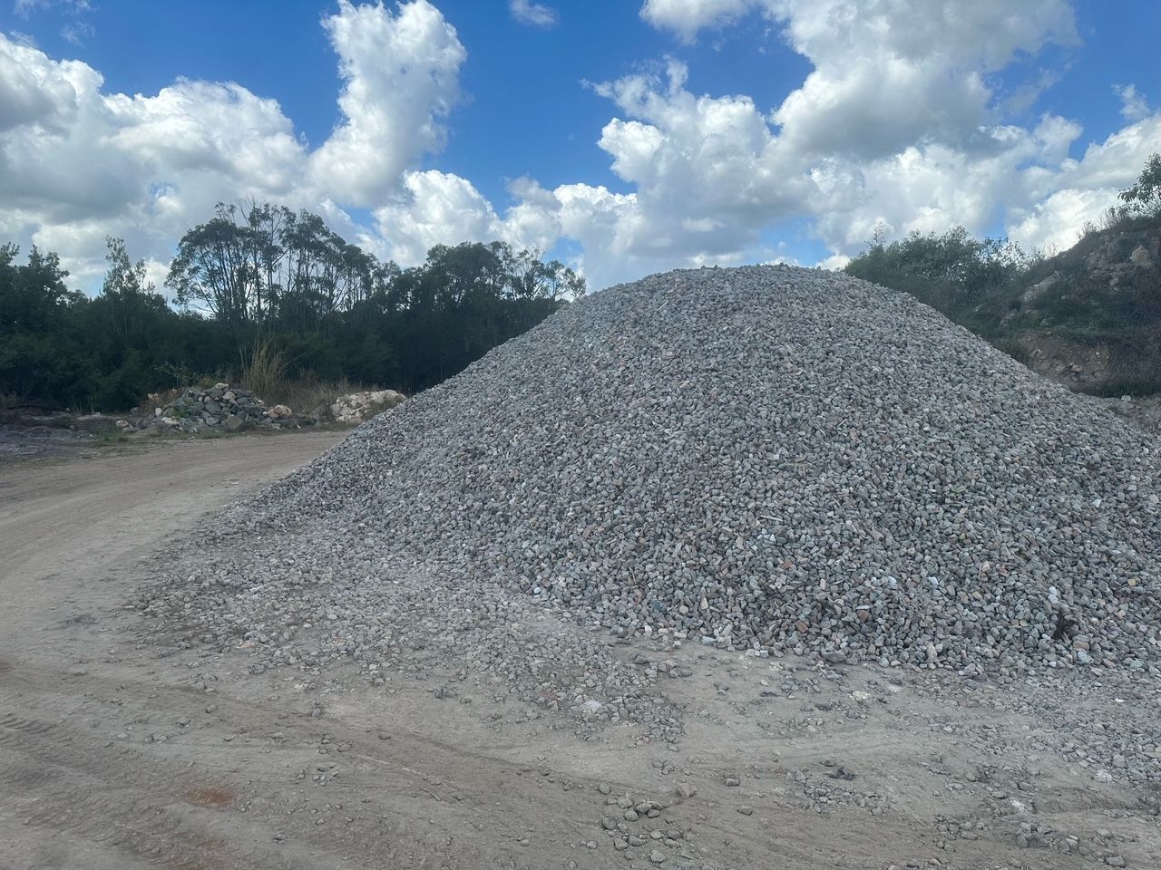 Dump Truck Bed Tilted, Unloading Brown Soil Onto a Pile — Coastal Sand Soil & Mulch in Craignish, QLD
