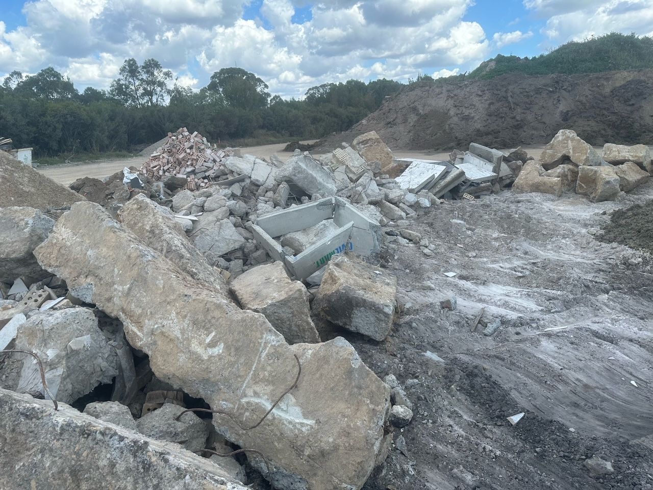 Large Concrete Rubble Piles in a Barren Quarry Under a Cloudy Sky — Coastal Sand Soil & Mulch Craignish, QLD