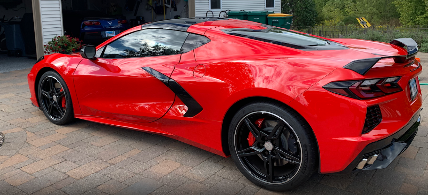 red car parked near the garage