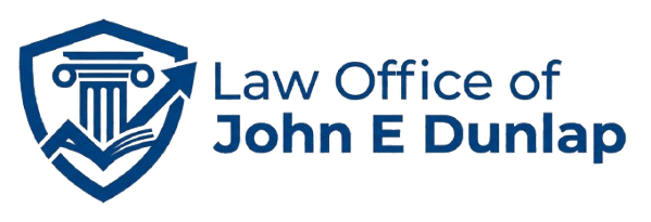 Blue shield law office logo with scales of justice and text “Law Office of John E Dunlap”