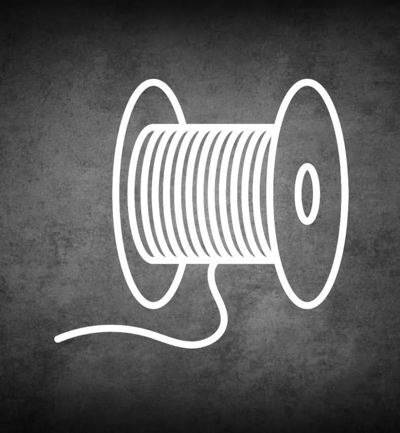 Spool of white wire on a dark textured background.