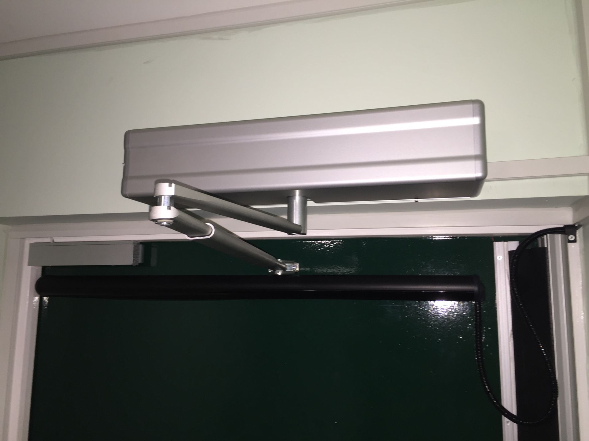 a door opener with a gray box on top of it