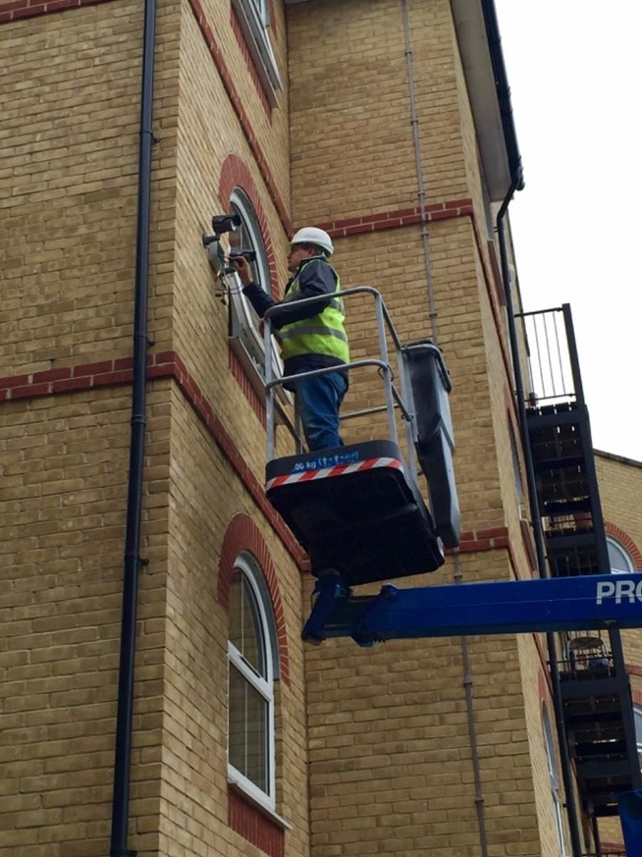 a man is working on a building with a lift that says pro