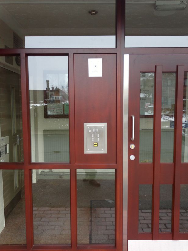 a wooden door with a stainless steel trim and a sliding glass door