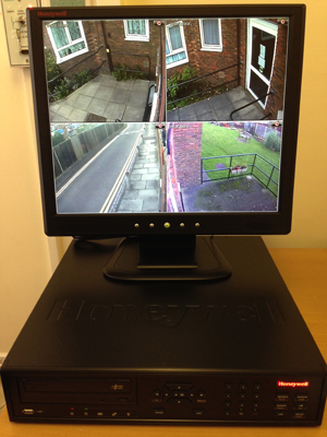 a honeywell monitor displays four different views of a house