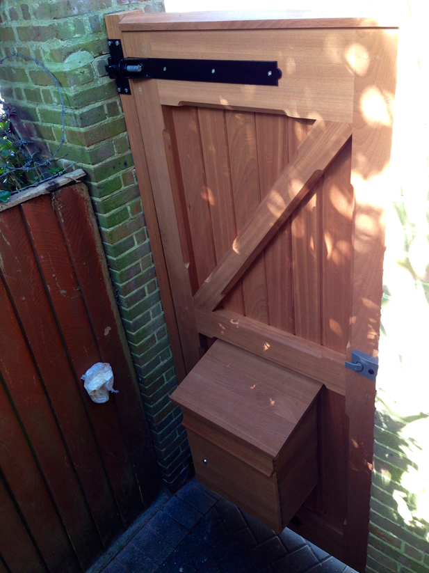 a wooden door with a mailbox attached to it