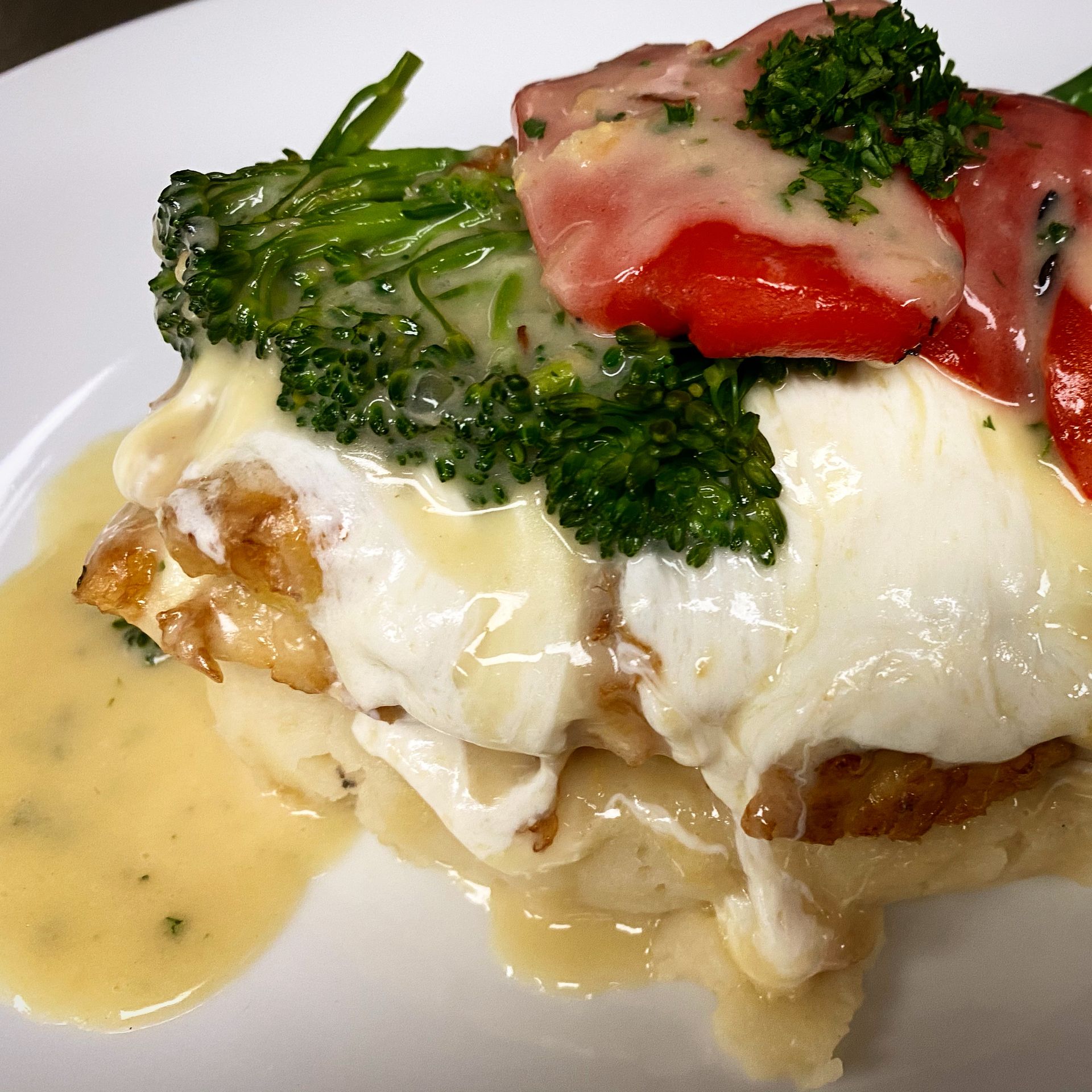 A close up of a plate of food with broccoli and sauce