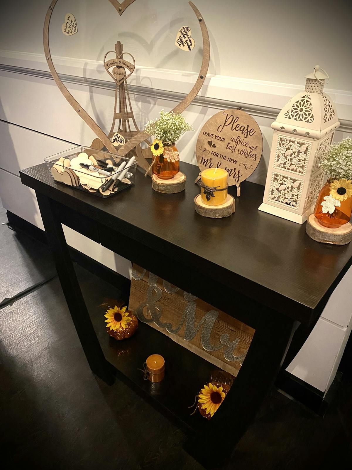A table with candles , flowers and a heart on it.