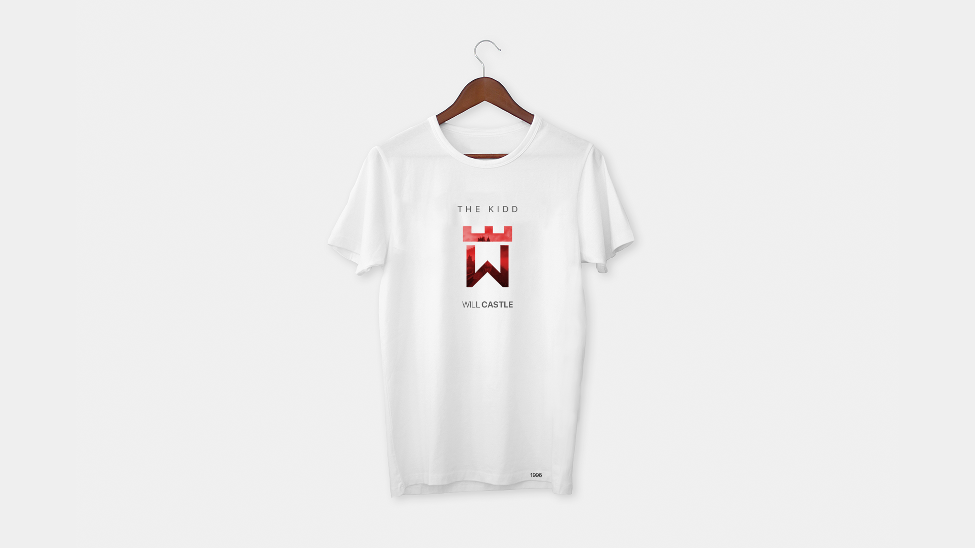 A white t-shirt is hanging on a wooden hanger.