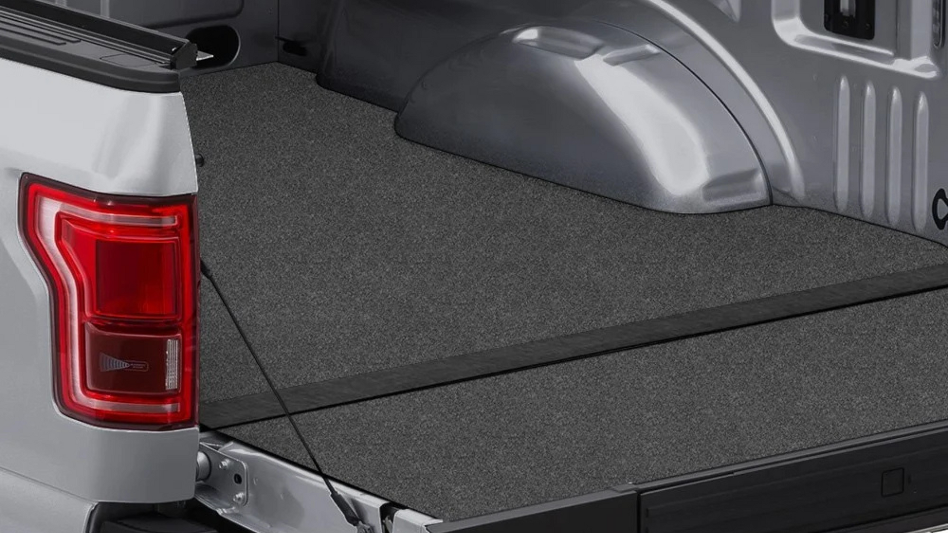 Gray truck bed with a black rubber bed mat.
