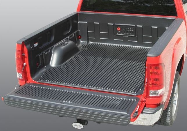 Red pickup truck bed with a black liner, open tailgate.