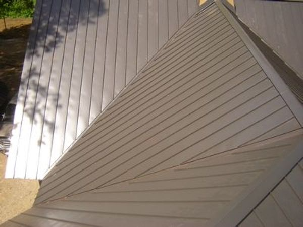 Metal roof with horizontal and angled panels.