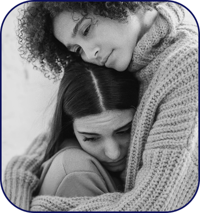 A friend comforting another friend with an embrace