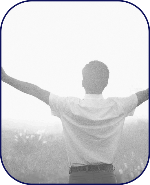 A man raising his arms amidst a sunny field