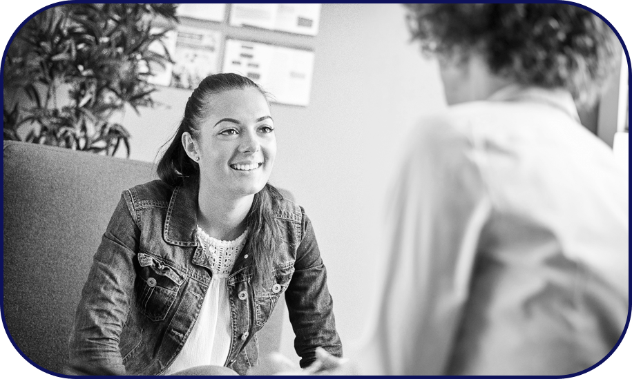 A mentee happily listening to her mentor