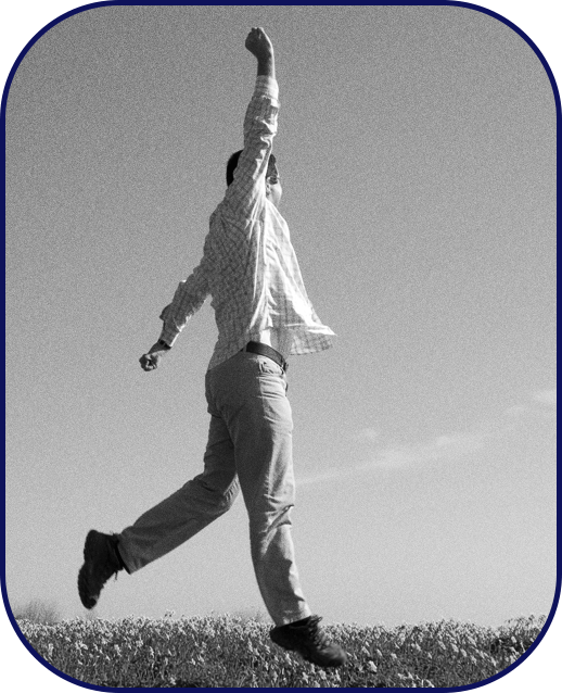 Man free from worry jumping in field