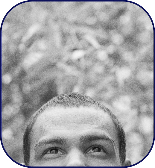 Man outdoors smiling with a peaceful gaze