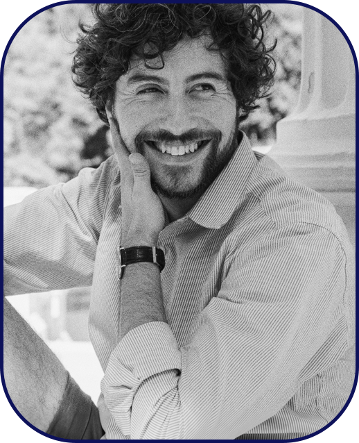 Man smiling while sitting amidst nature
