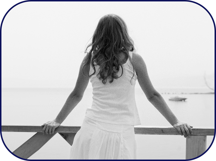 A relaxed woman looks out into the sea