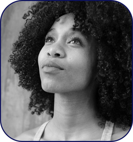 Young woman of color looking up and hopeful
