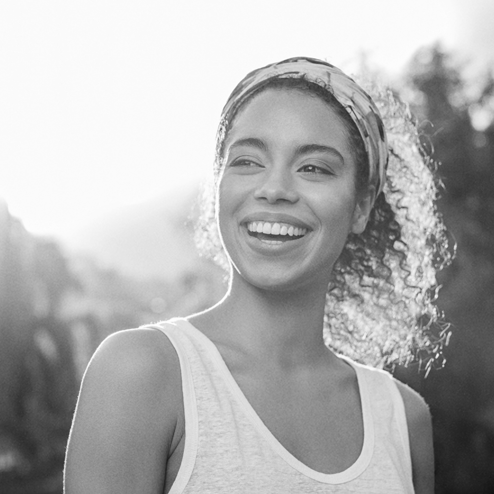 a smiling woman wearing bandana on her head