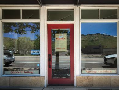 A red door with a sign on it that says open