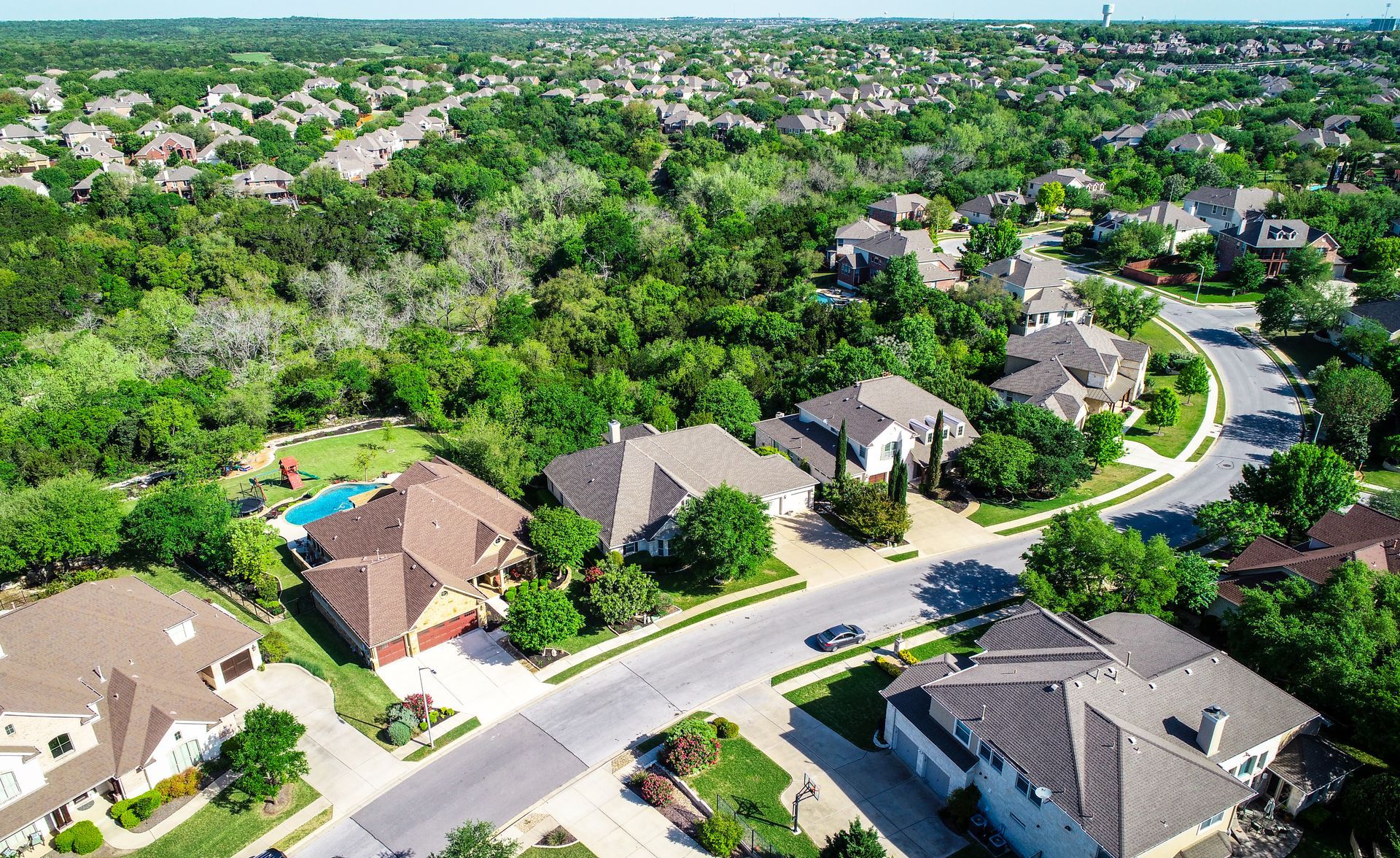 an aerial view of a residential neighborhood with lots of houses and trees .