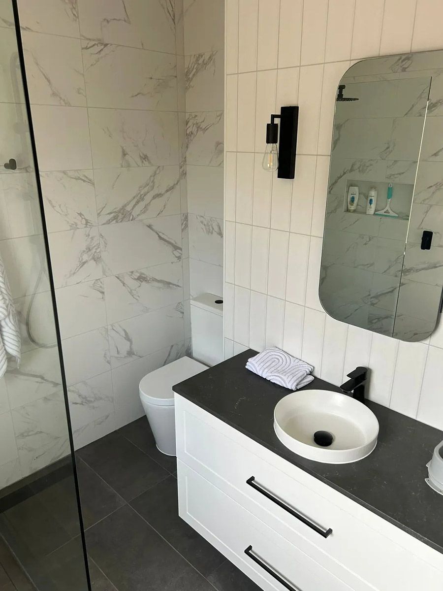 A Bathroom With A Toilet , Sink , Mirror And Walk In Shower — Ultimate Bathrooms Ballarat In Alfredton, VIC