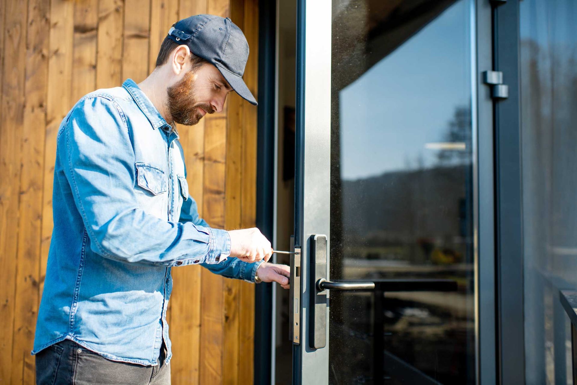 A locksmith adjusts the glass door lock, keeping the property secure. A locksmith adjusts the glass door lock, keeping the property secure.