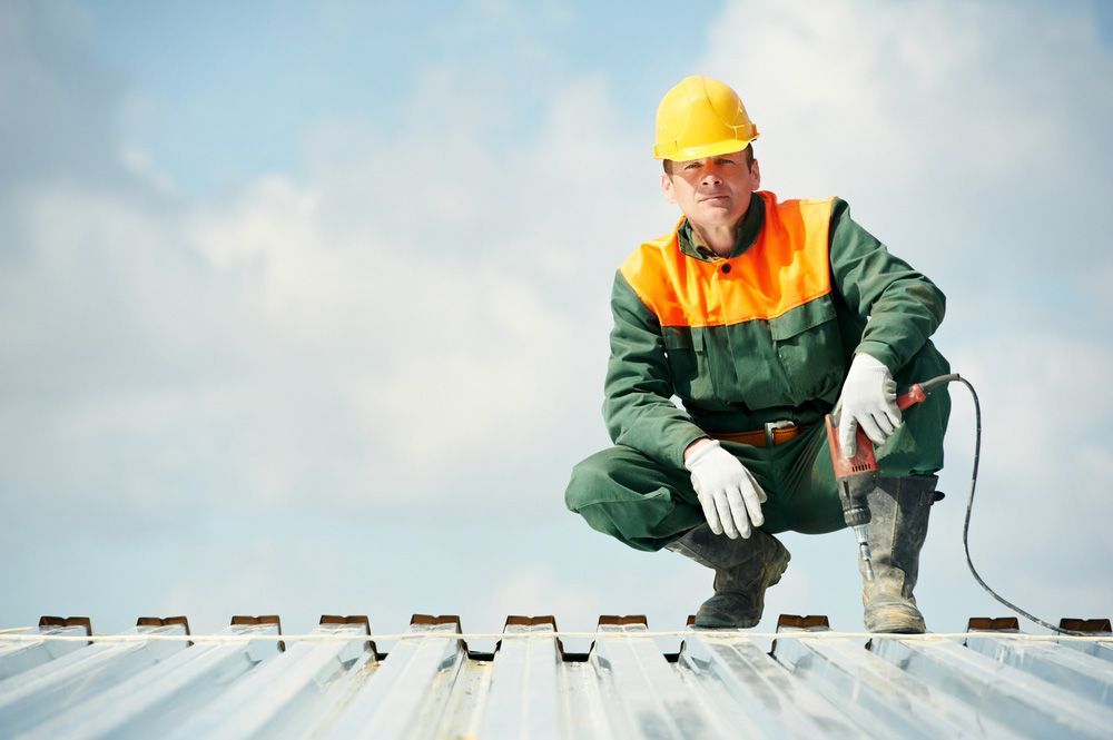 Man Wearing Protective Suit is Kneeling on a Roof — Uniforms2U in Leumeah, NSW