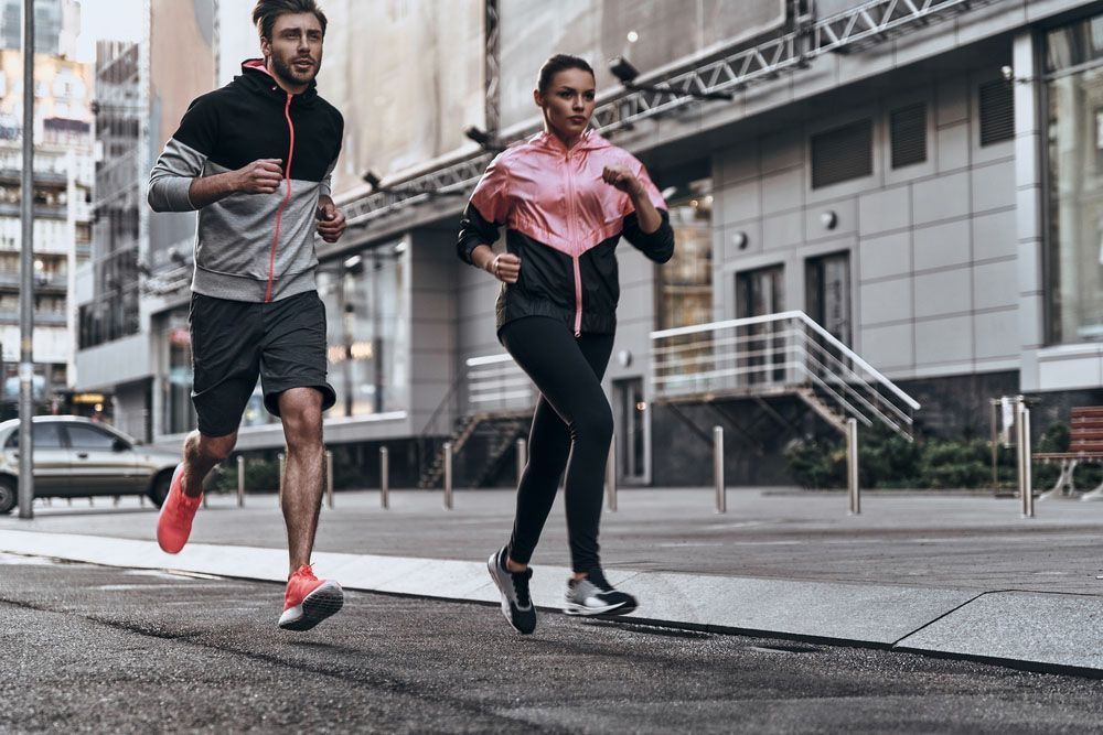 Man and Woman Are Running on a City Street — Uniforms2U in Campbelltown, NSW