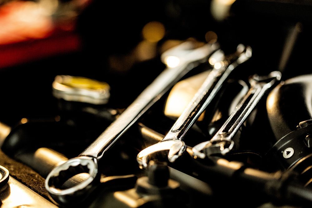 A Bunch of Wrenches Are Sitting on Top of a Car Engine — A & J Diesel Services in Braitling, NT