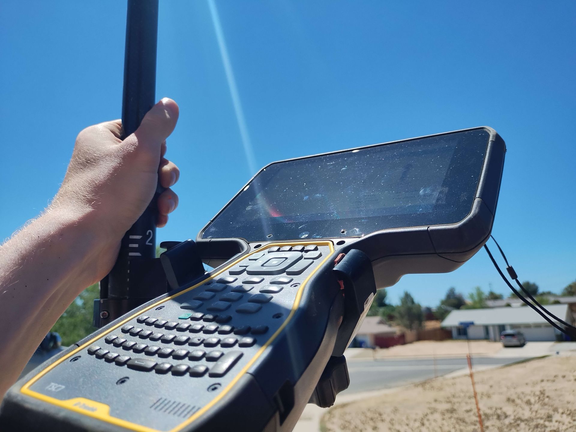 A person is holding a black and yellow device in their hand