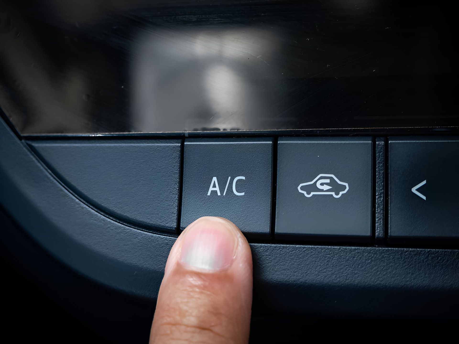 A Person Is Pressing The A / C Button On A Car Dashboard — Lismore Tecnicair In South Lismore, NSW