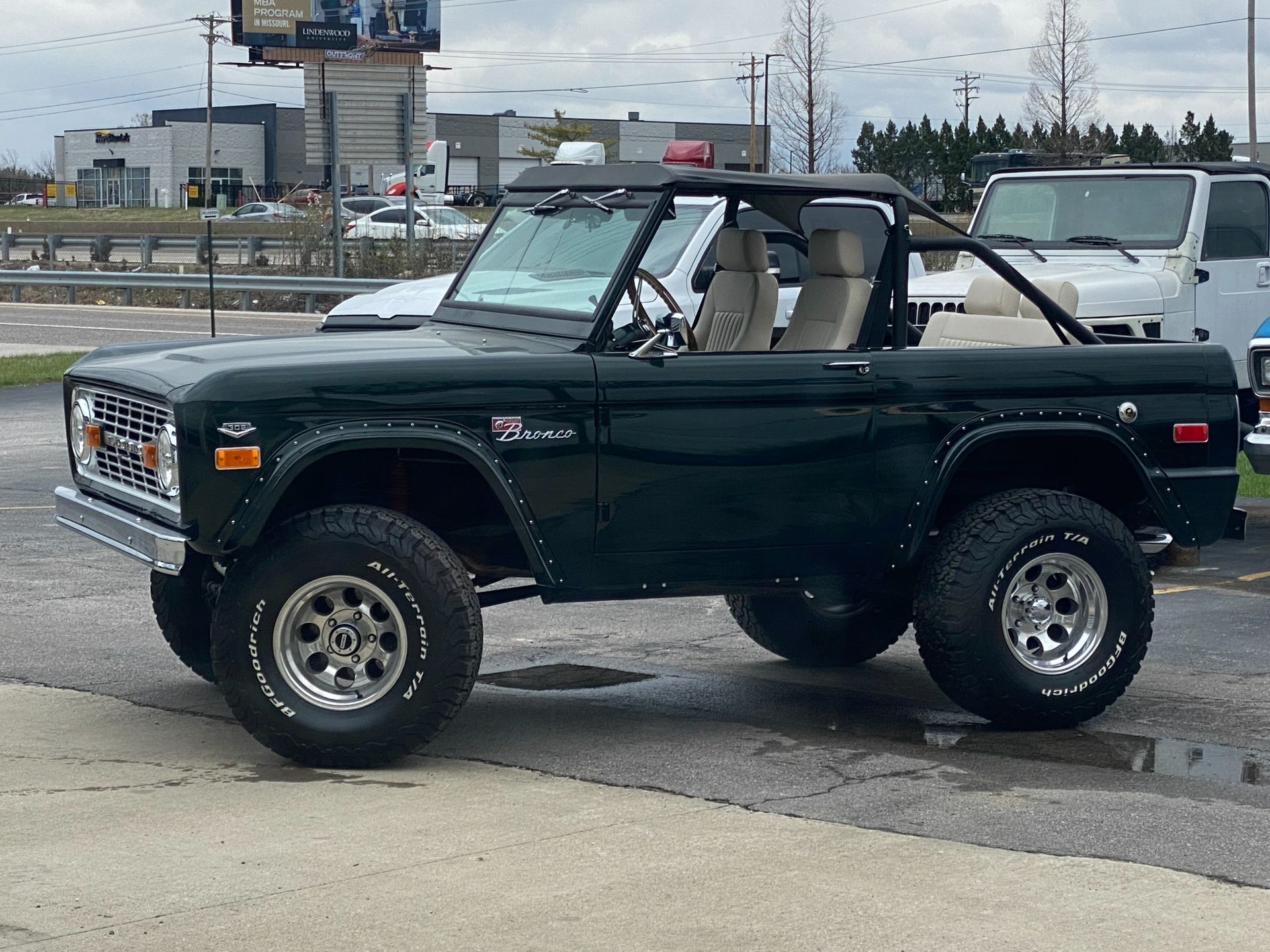 Black open-top sport utility vehicle with tan leather interior and chrome details parked on asphal