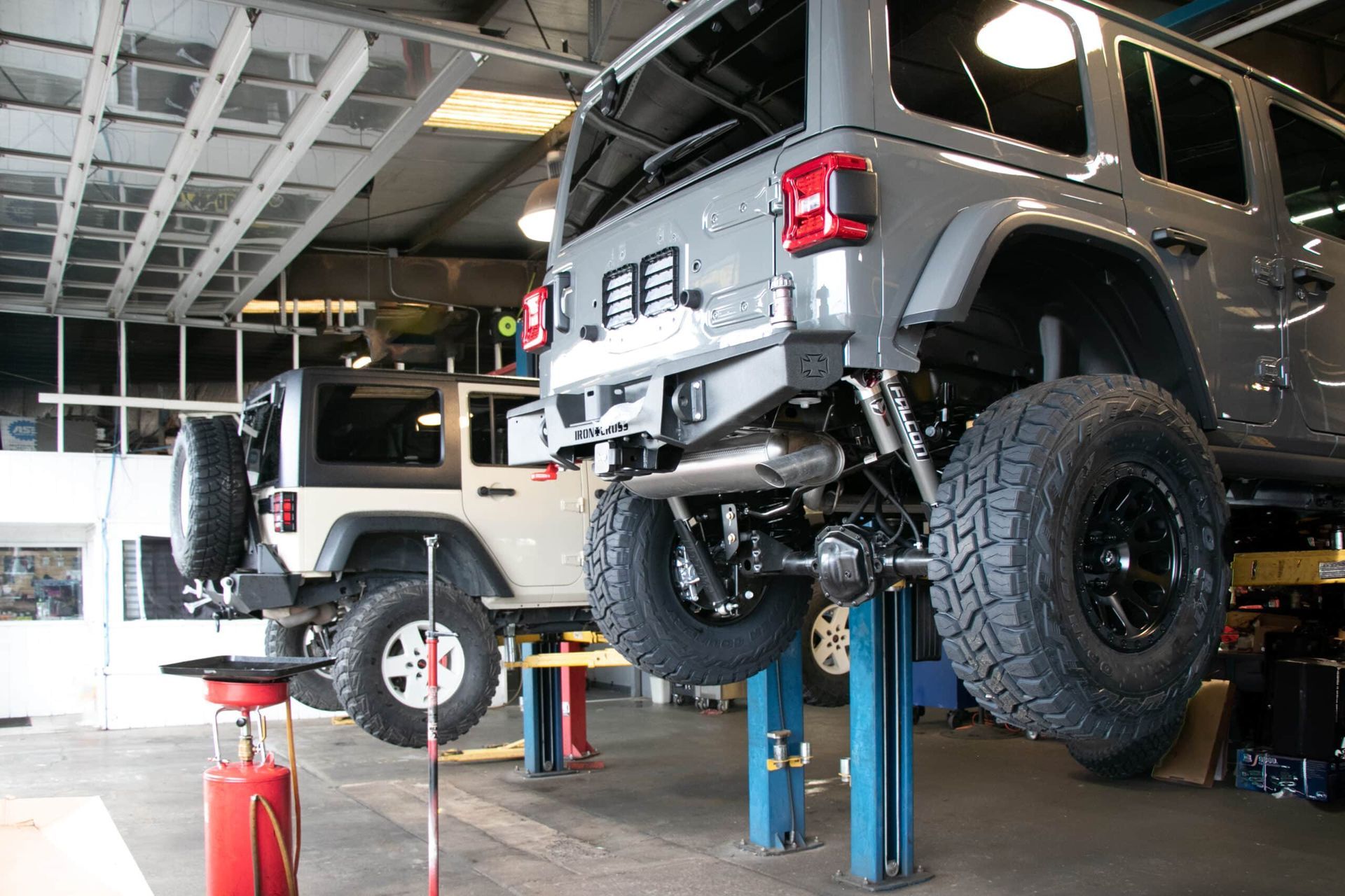 gray 4x4 lift kit installation on a lift platform, showing back end lift