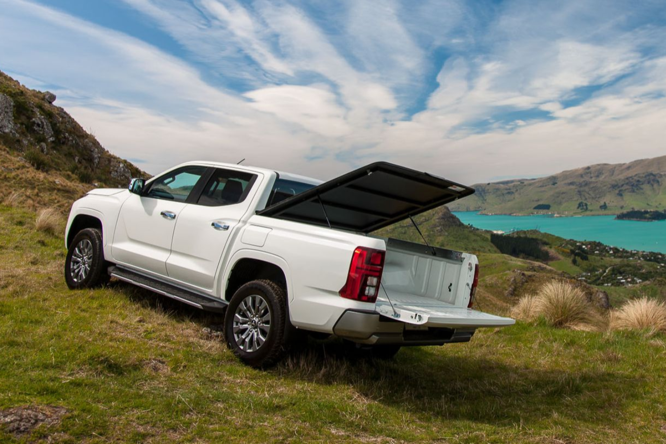 Mitsubishi Triton with MAXIM Hard Lid on a hill with a bay view.