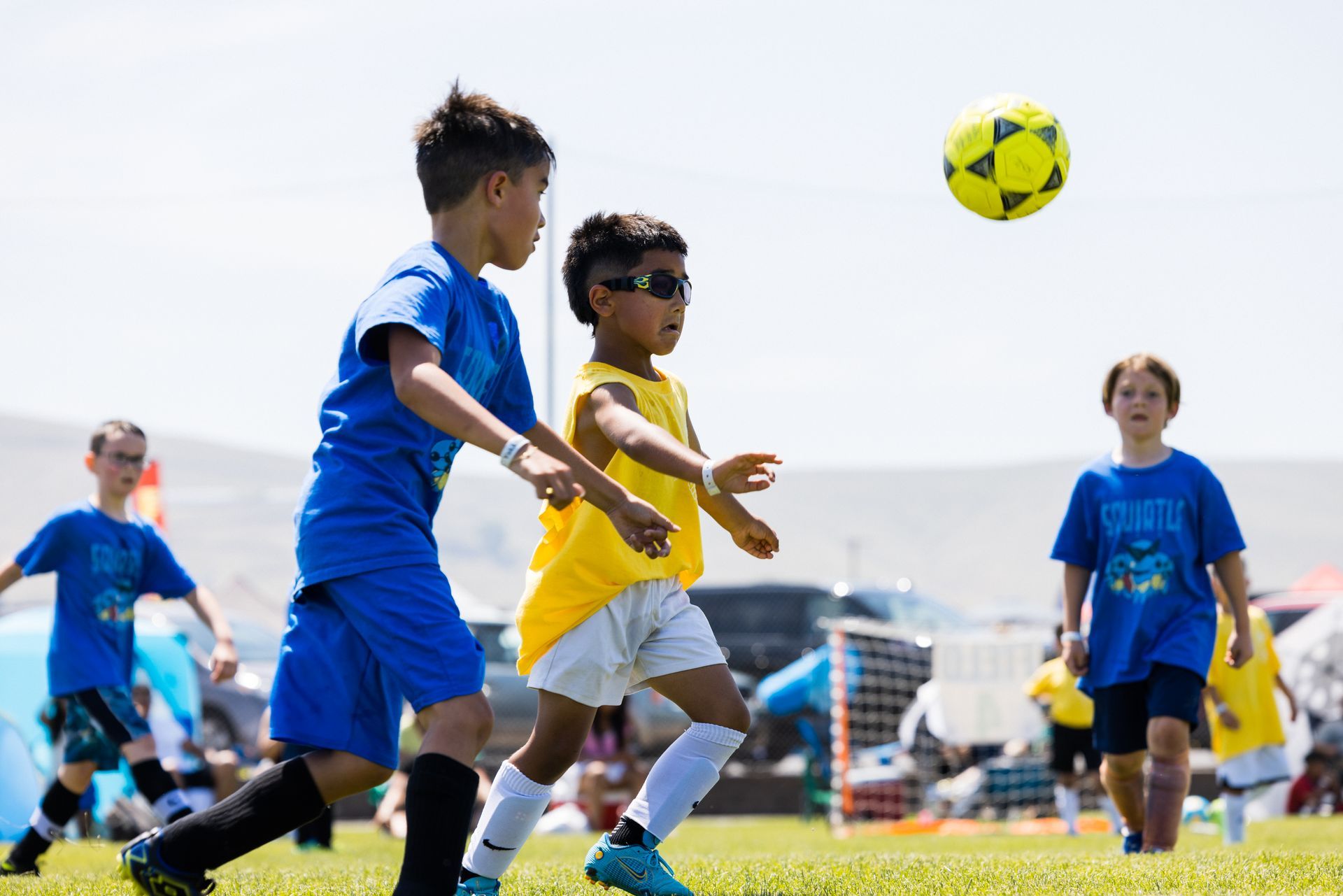 A group of young boys are playing soccer on a field.