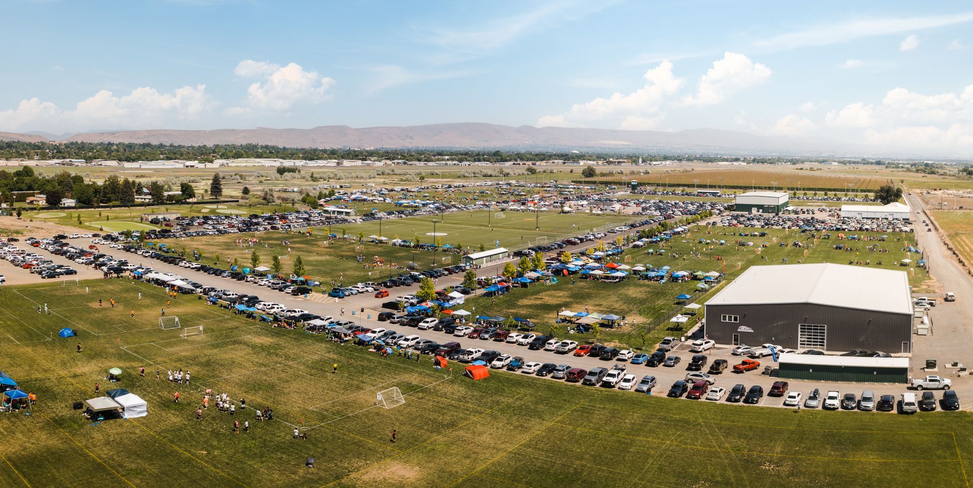 An aerial view of a large parking lot filled with cars.