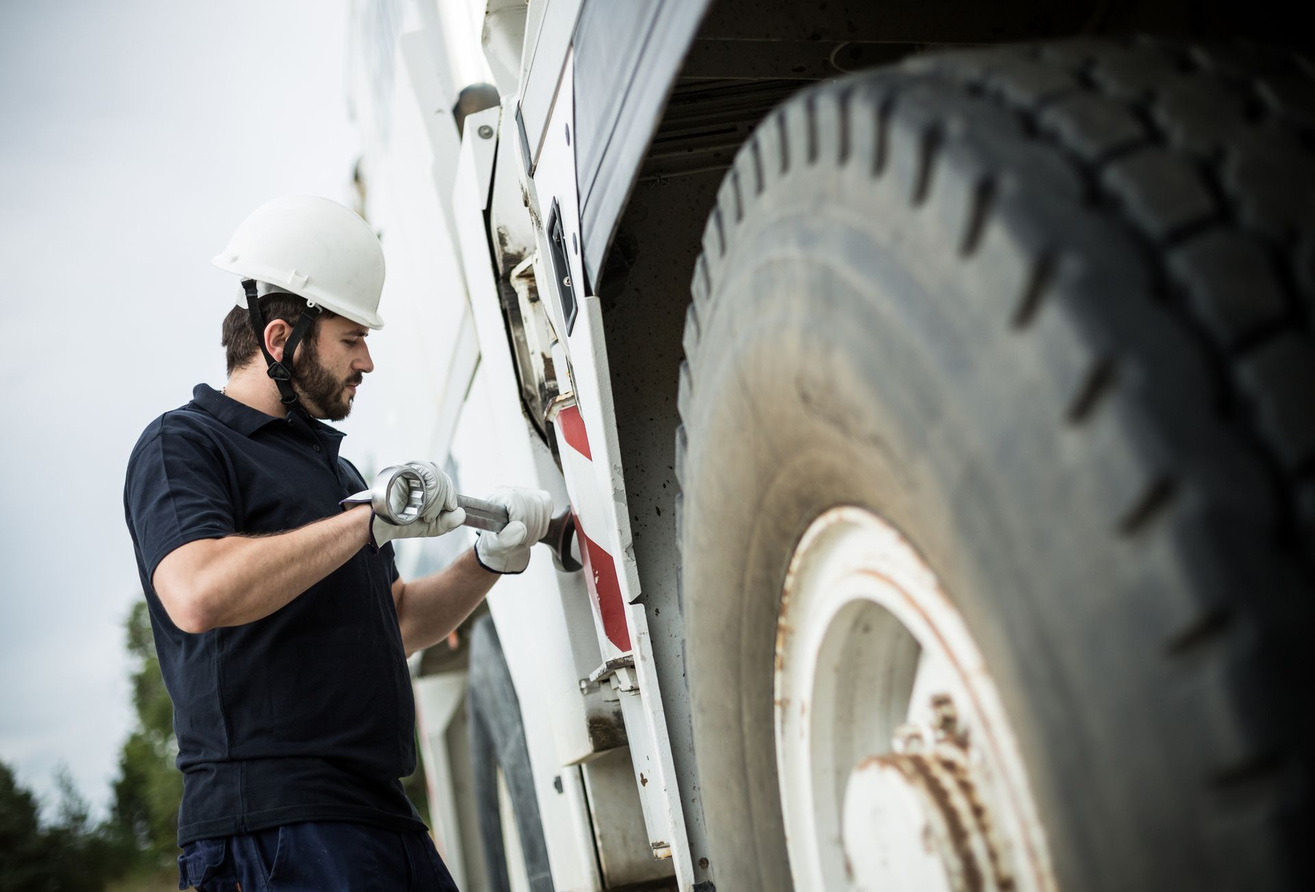 A person in a hard hat fixing a truck | Truck Repair Services Plainfield IL | MRW Truck Repair