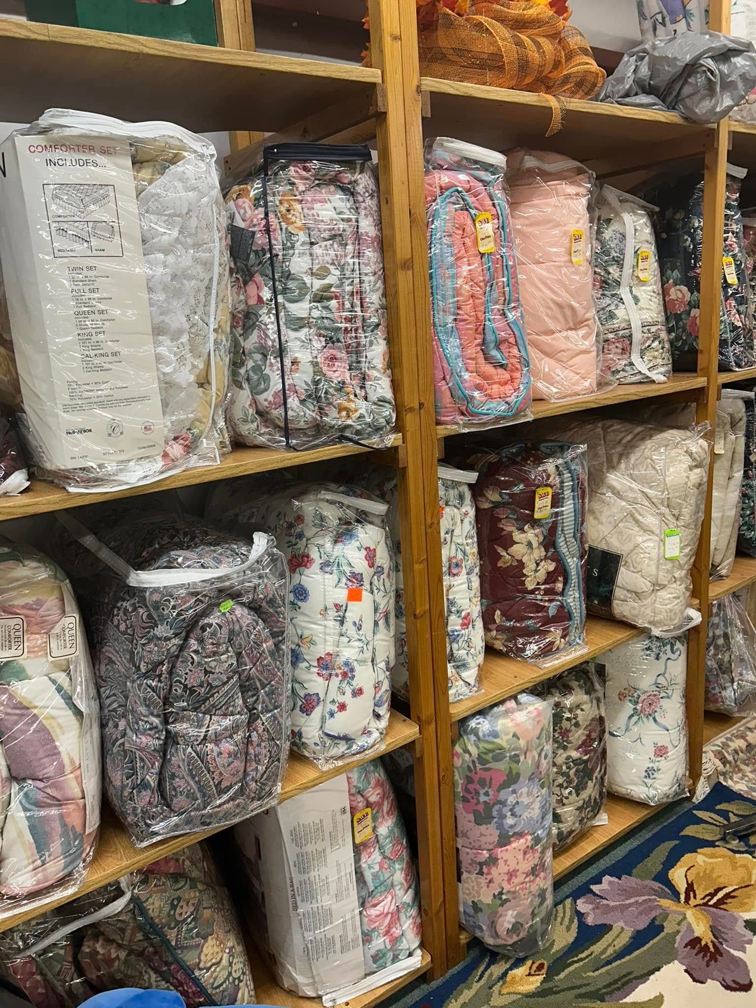 Shelves stacked with colorful patterned fabric rolls in a shop or storage area